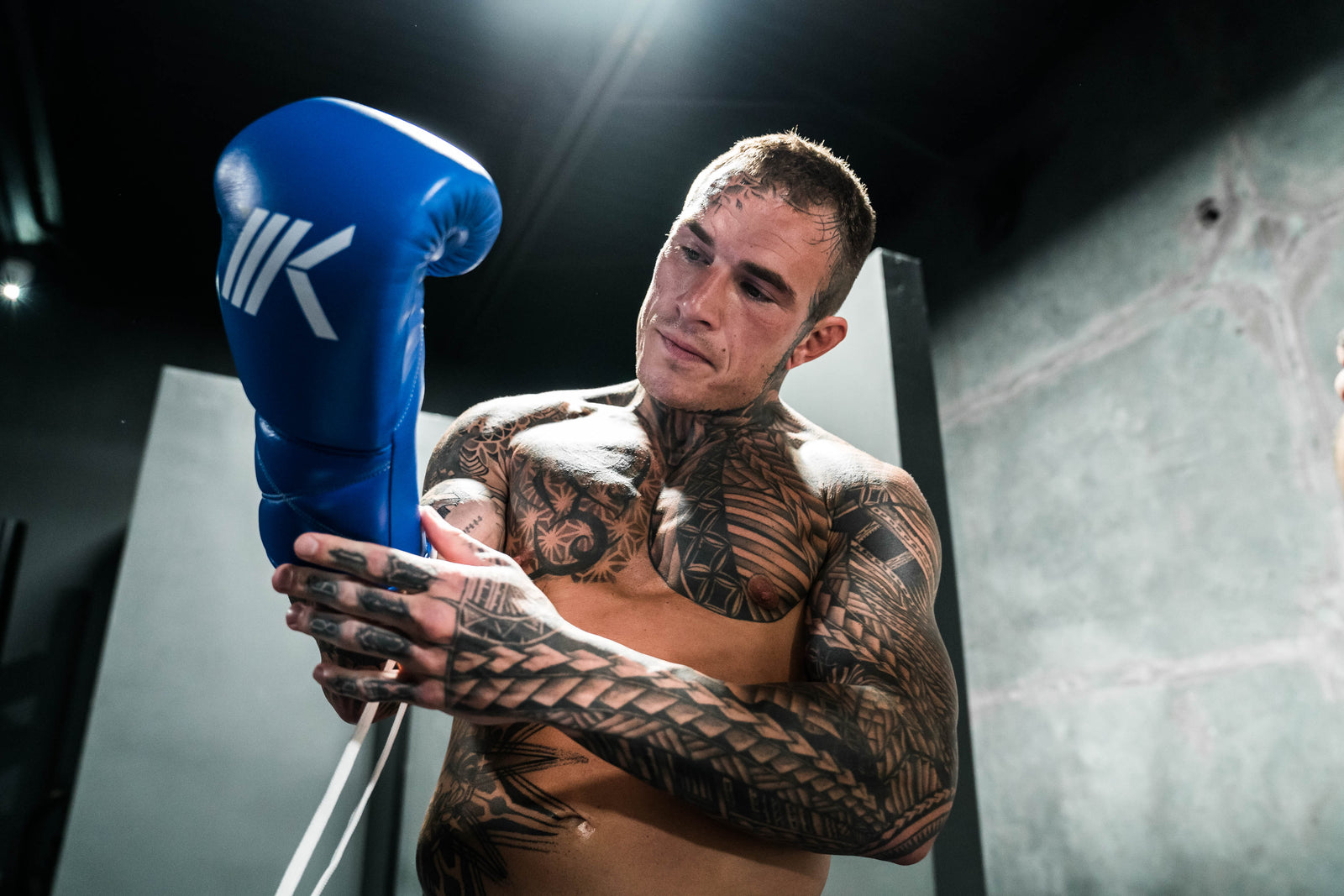 Jake "Brutal" Bostwick lacing up "Select" Boxing Gloves.