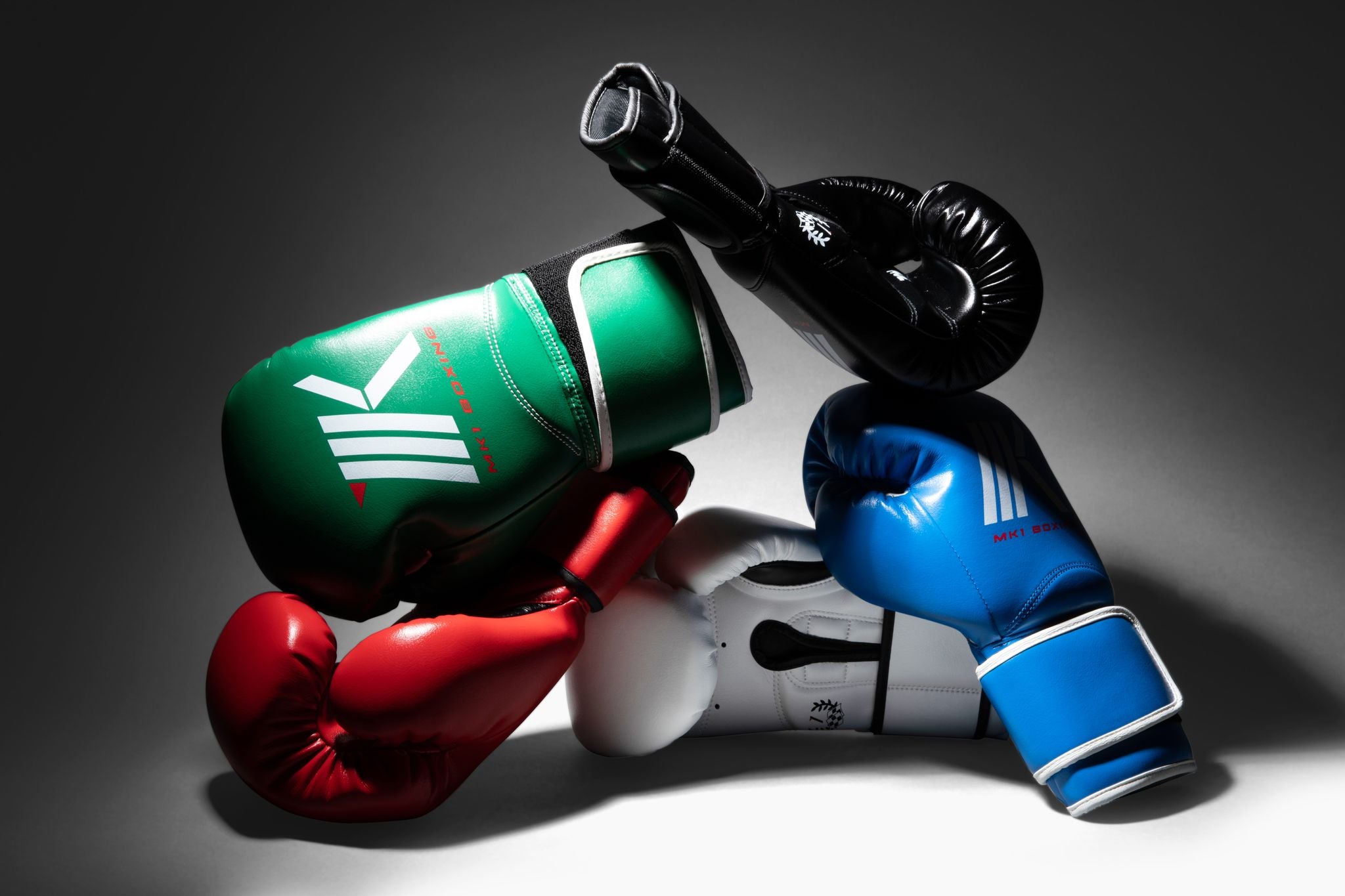 Collection of MK1's Mark-1 Training Gloves Assorted by color in red, blue, white, black, and green. 