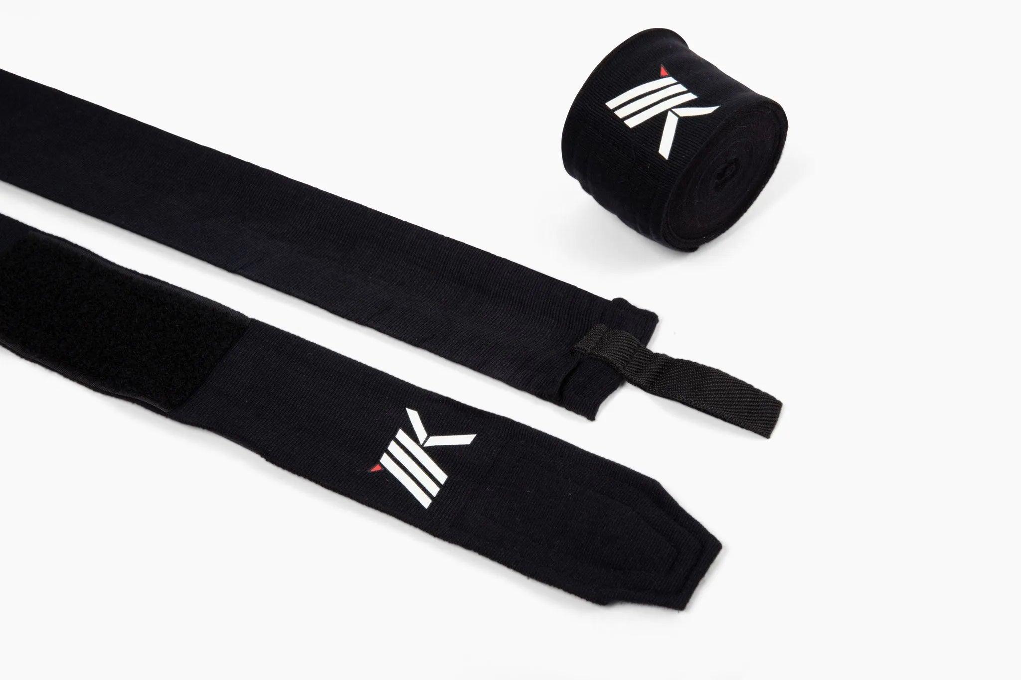 Black pair of 180-inch premium boxing hand wraps by MK1 highlighting their loop thumb closure and secure strap. 