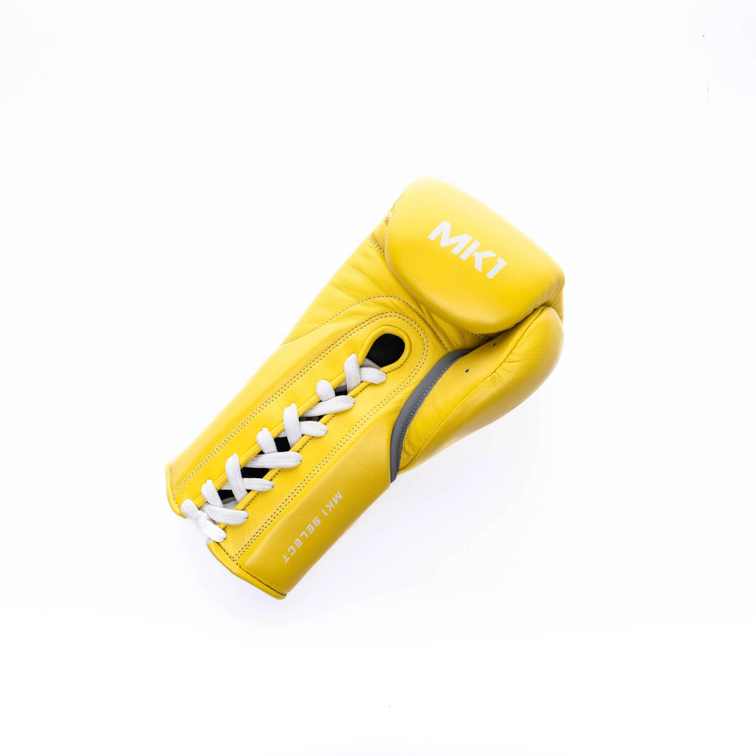 Yellow lace-up boxing gloves handcrafted in genuine leather with a lace-up closure.  
