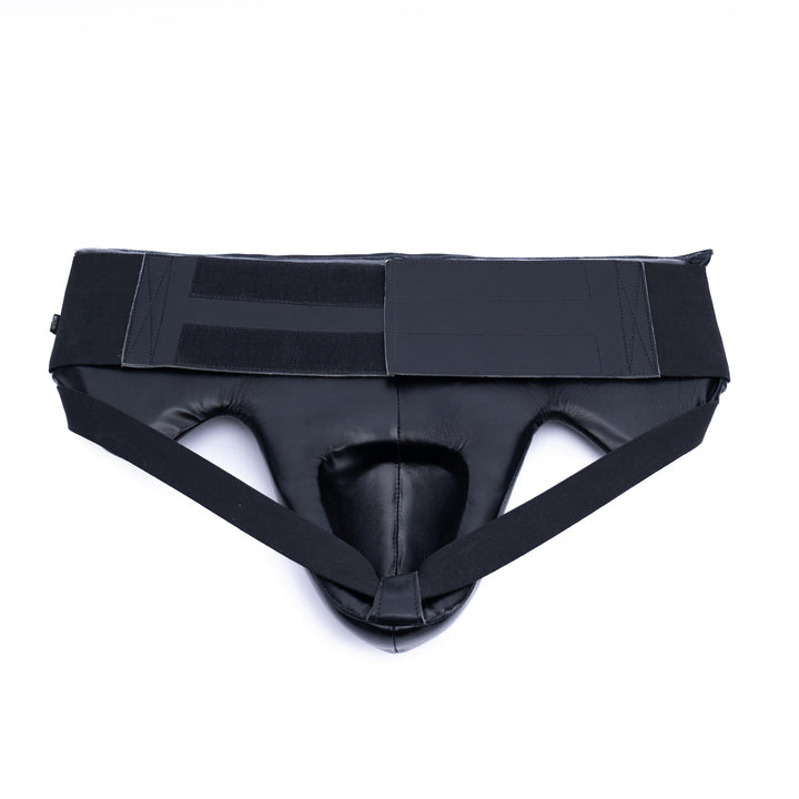 Black groin guard closure featuring a velcro strap for a secure fit during sparring.