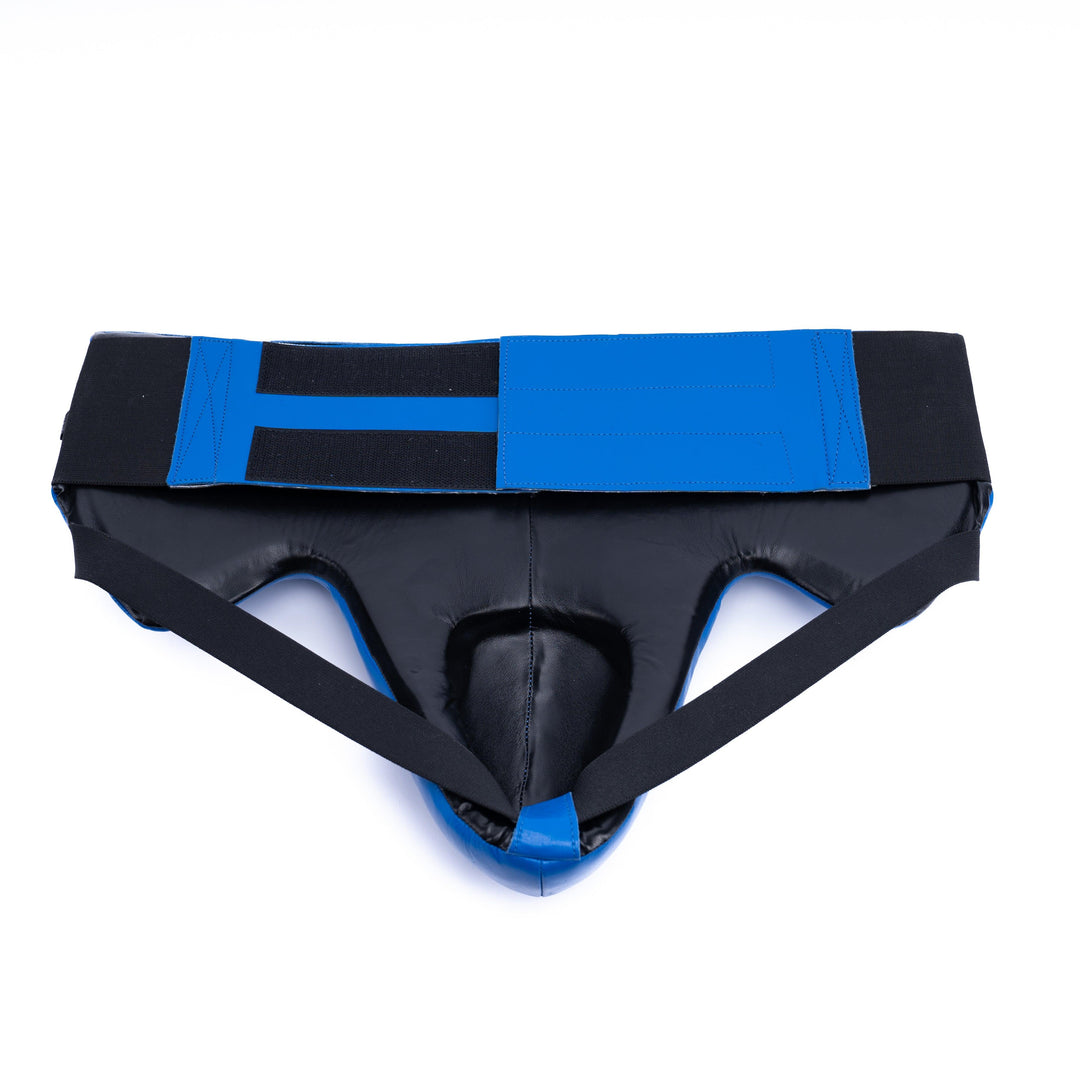 Blue groin guard closure featuring a velcro strap for a secure fit during sparring.